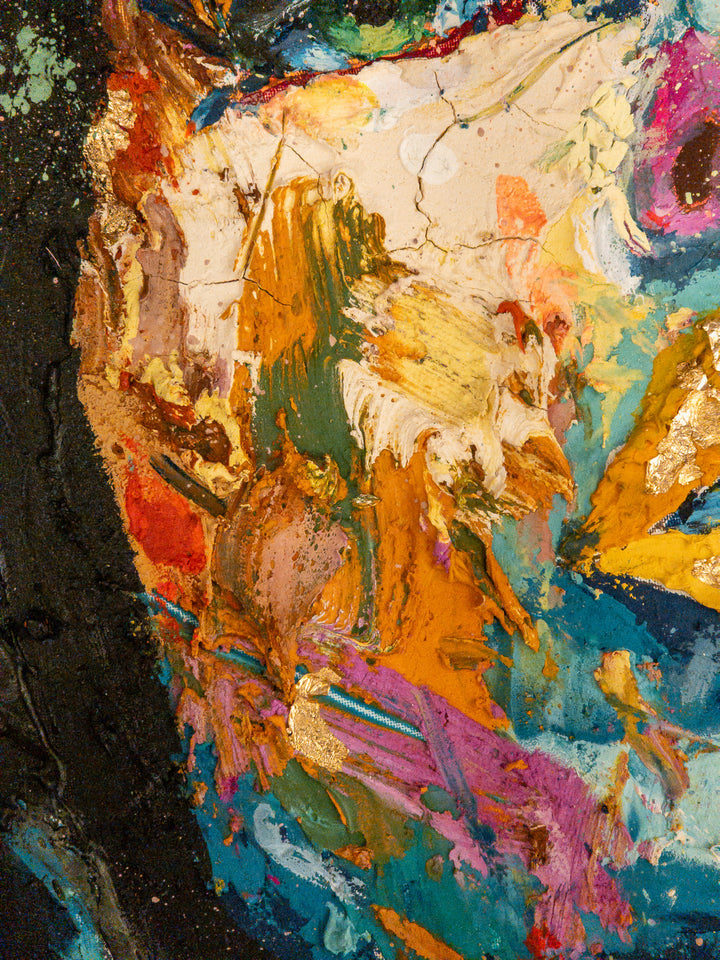straight on portrait womans head looking up with green eyes multicolored face painted thick and abstract with black splatter hair and gold foil