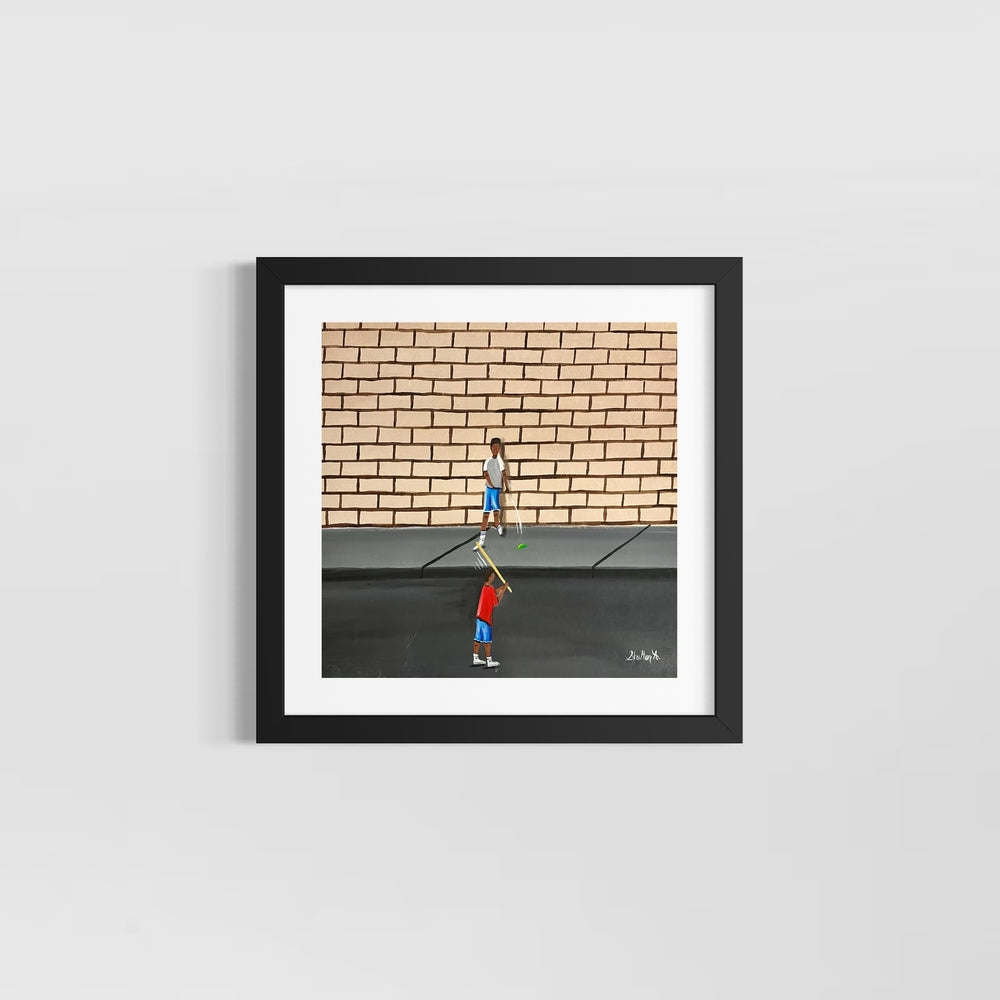 two boys playing outside game with stick and ball in street in front of brick wall