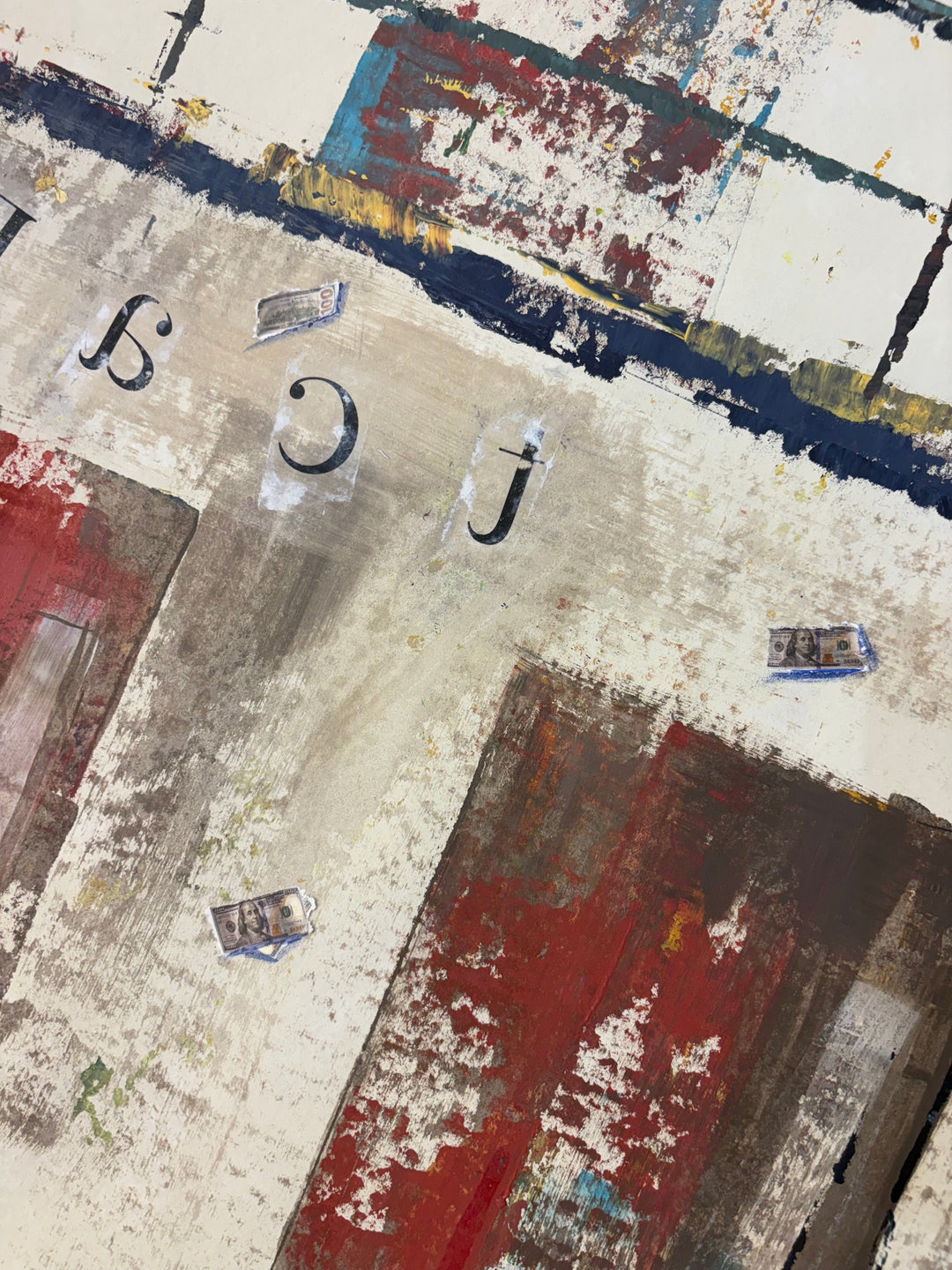 Angled detail of Block to Block by Keith Andrews, showing the upper cell block wall with reversed stenciled letters, small collaged paper bills, and red and cream brushstrokes.