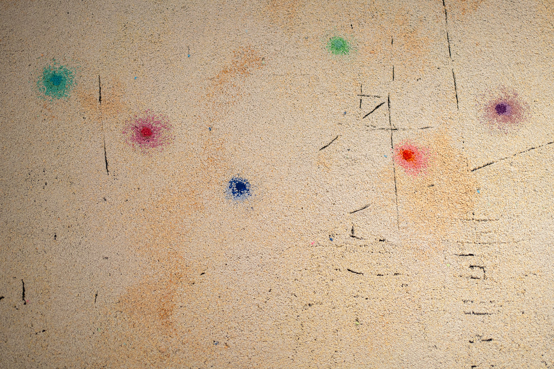 pigmented volcanic rock on canvas in beige tone with dots of color blue red purple green and static line across bottom abstract minimal textured painting