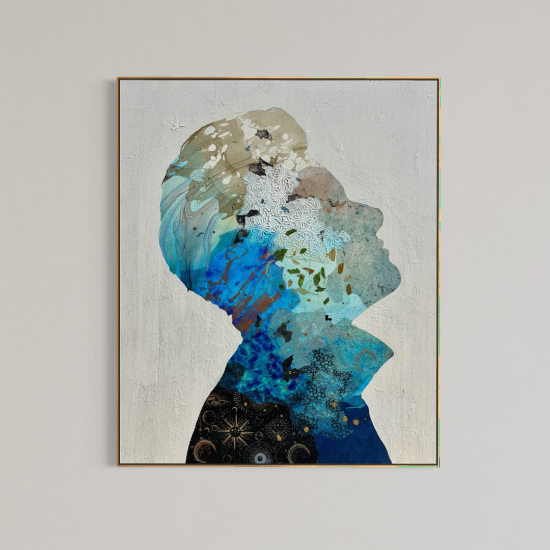 Christopher Peter, Born to Be Blue, acrylic, oil, handmade papers and gold leaf on canvas, 48 x 40 inches. The painting shown in a thin gold-toned frame on a light gray wall, depicting an upward-facing profile silhouette filled with blue, turquoise, tan, and black collaged papers on a textured off-white background.