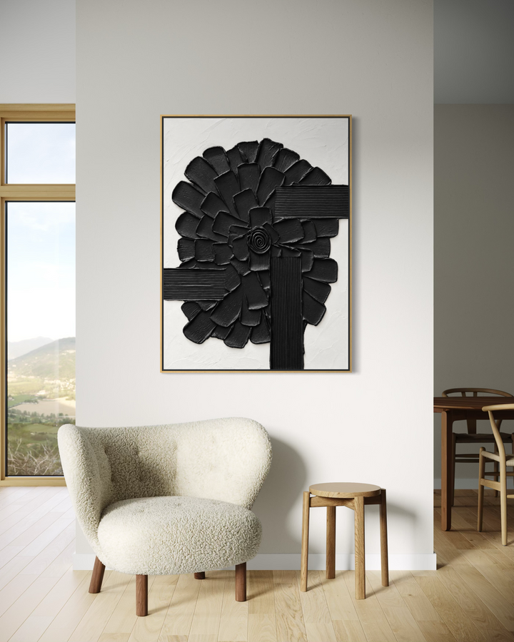 Lee in Cerulean, Botanic Vaste, joint compound and acrylic paint on canvas, 48 x 36 inches. Black and white textured floral painting in a thin wood frame, hung above a cream boucle armchair and a wood stool beside a window with a hillside view.