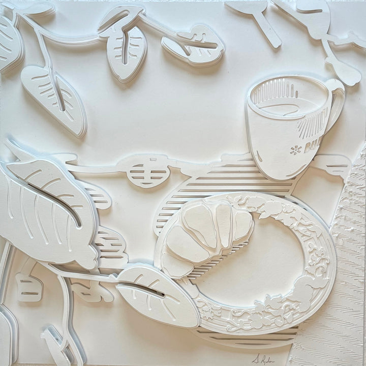 14"x14" layered white paper forming a table with breakfast and vegetation.  
