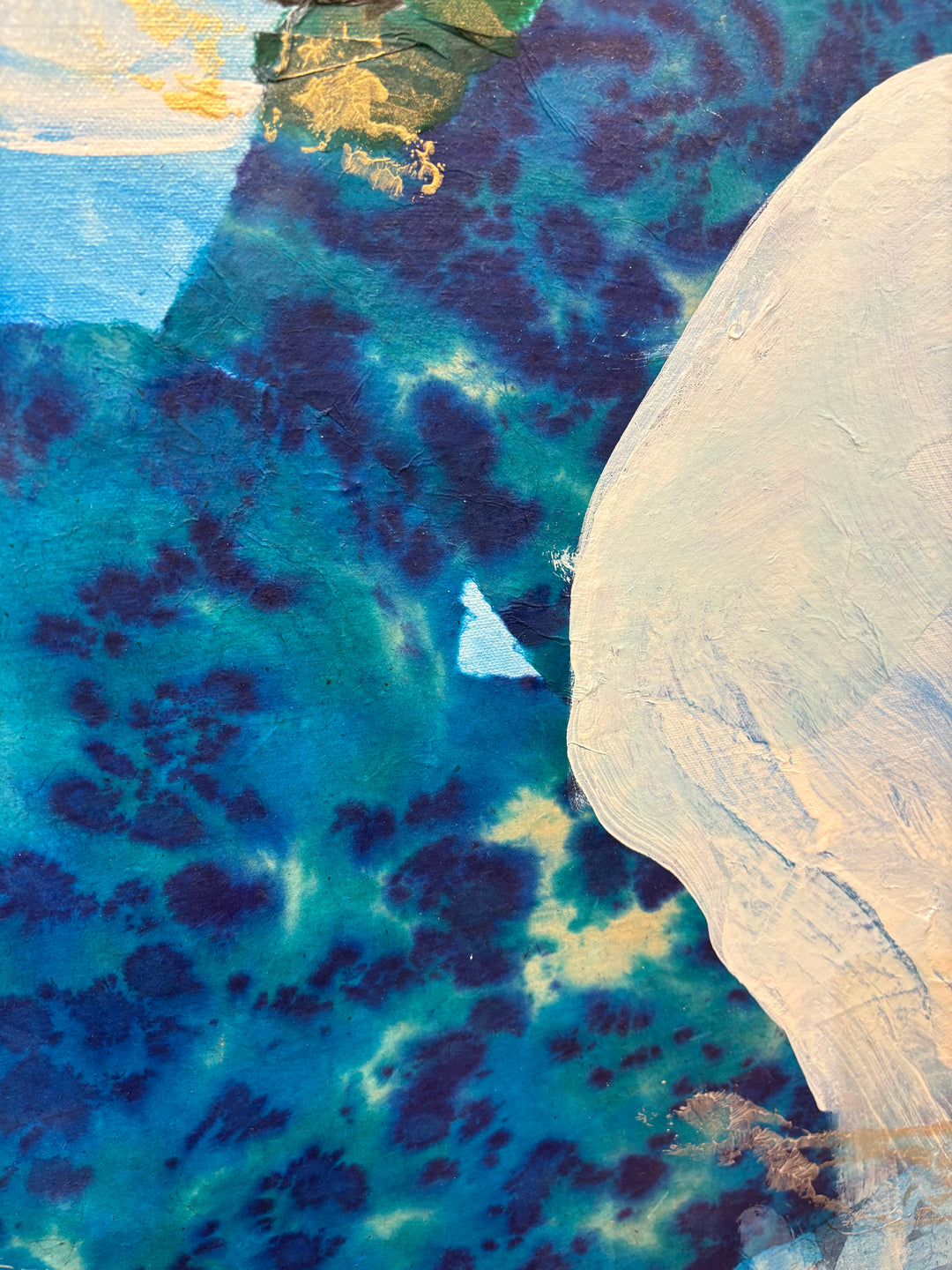 Close-up detail of Current Cameo showing the neck and lower face area, featuring deep indigo and teal floral-patterned paper with visible dark blue blossoms, contrasted against a textured cream-white neck silhouette.