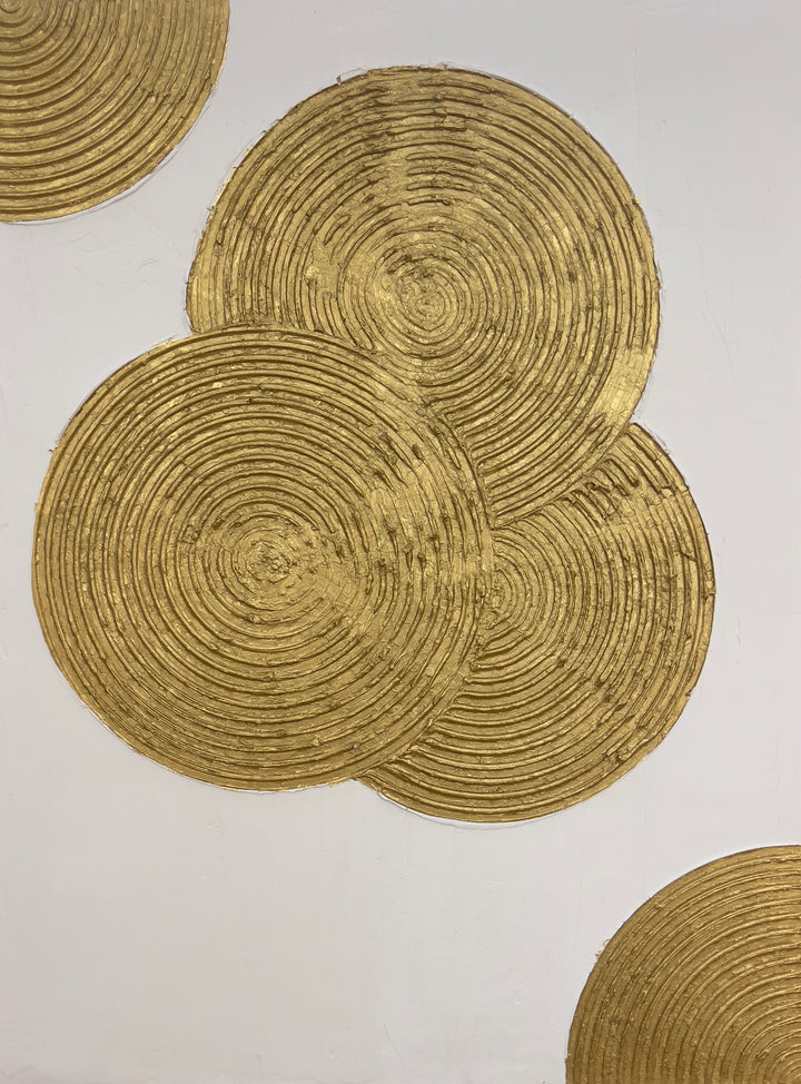 Dilation by Lee in Cerulean. Textured grouping of three spiraled circles overlapping with each other in gold on white background, with two more quarter spiral shapes in top left and bottom right corner