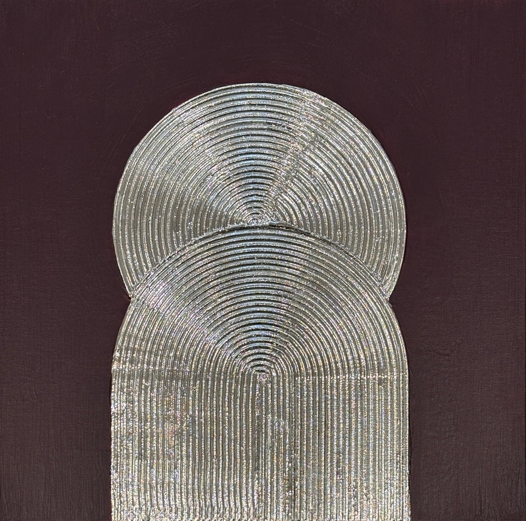 Lee in Cerulean, Eminence Duo I, joint compound, liquid leaf and acrylic, 14 x 14 inches. Two overlapping silver forms, a circle above an arch, both formed from concentric raised lines, on a dark plum background.