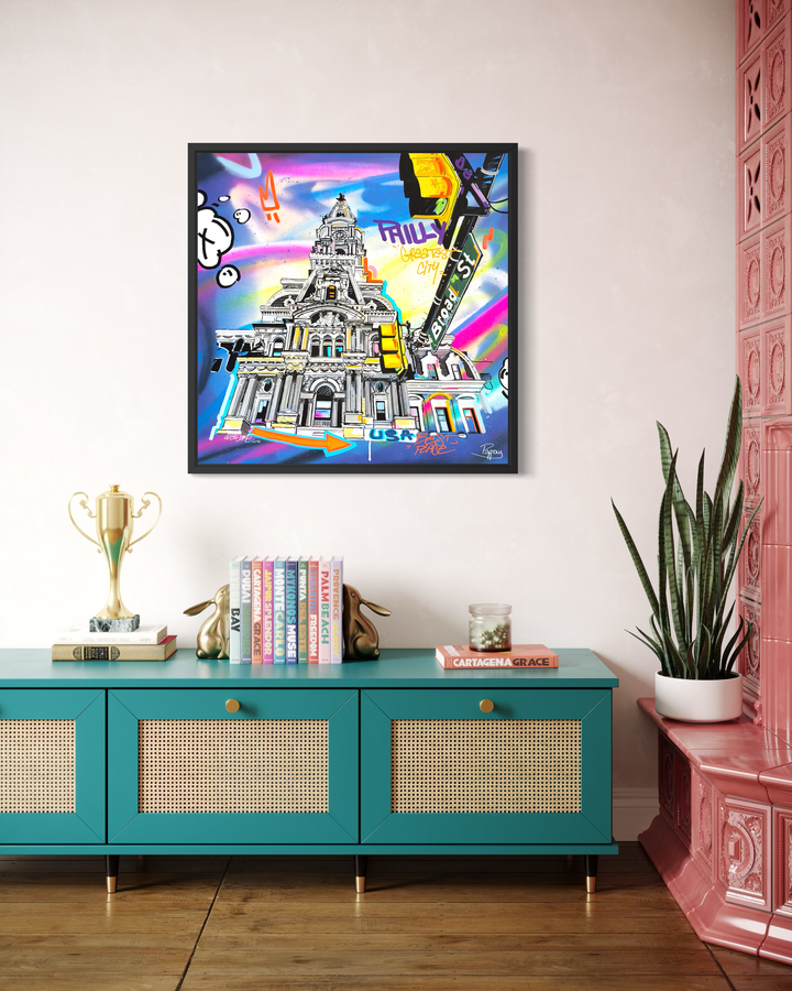 Framed "Greatest City" graffiti painting by Pappay displayed above a teal credenza, showing how the artwork looks styled in a living room