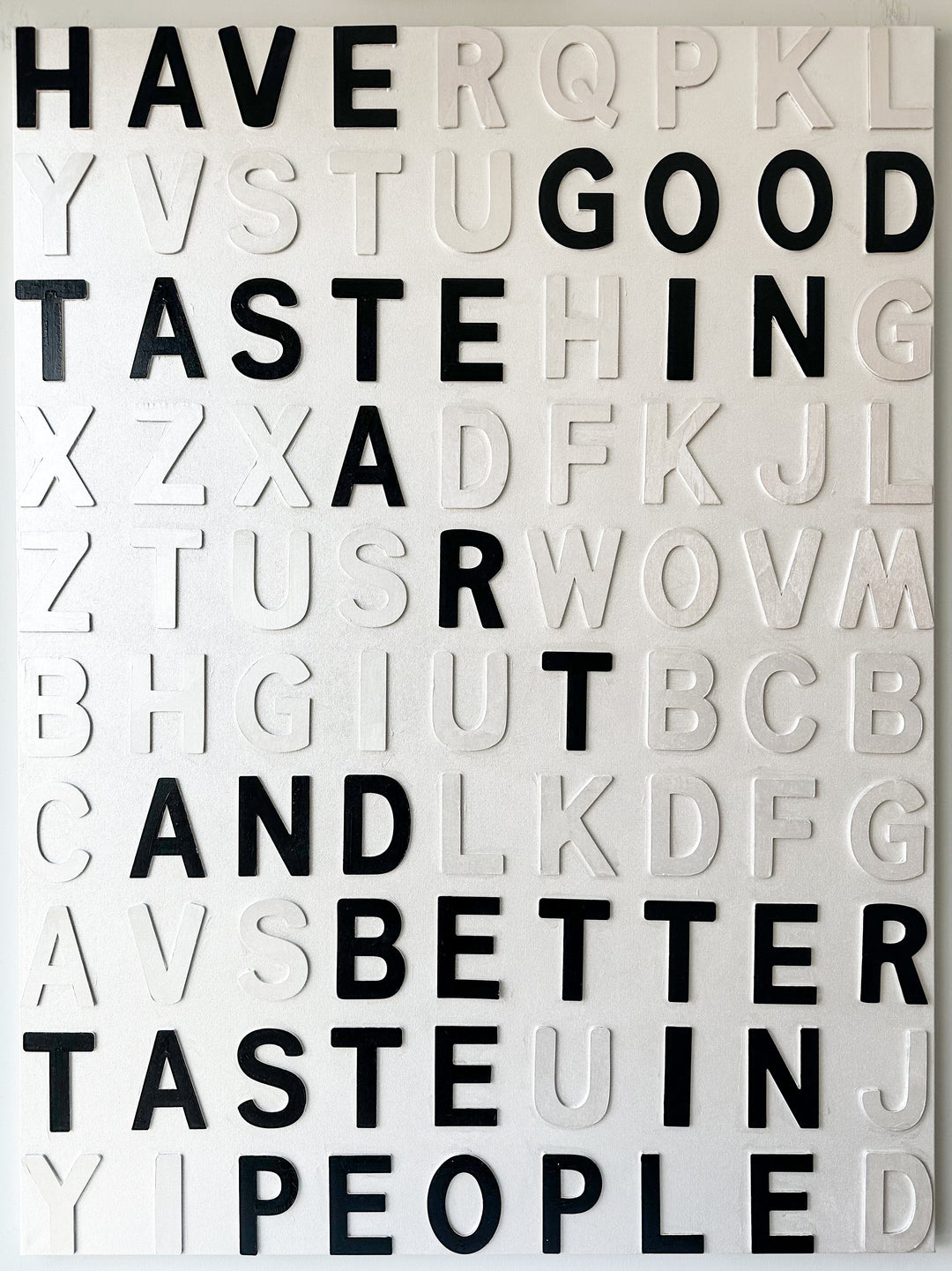 Steffanie Gerkin Have Good Taste White 3D, a contemporary mixed-media text artwork made with wood and acrylic on canvas, featuring raised black and white letters in a bold typographic composition.