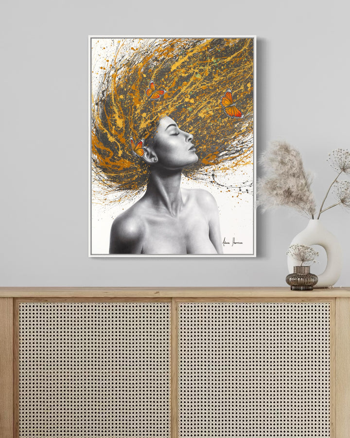 black and white profile woman flipping her hair on gold orange yellow and black splatter hair with orange monarch butterflies in hair on white background