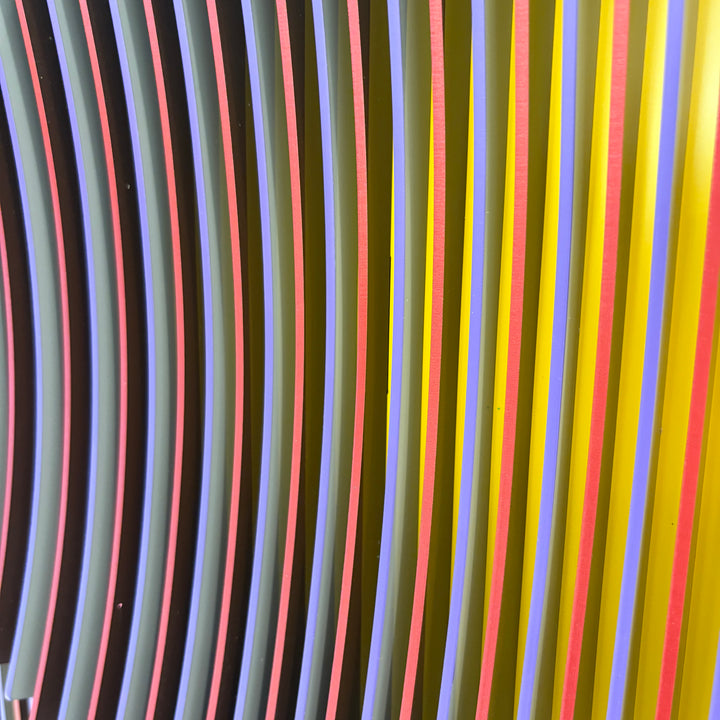geometric abstract vertical lines concave optical illusion of a circular shape in middle in yellow red and blue