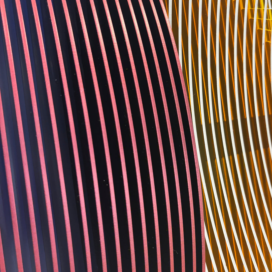 vertical stripes in purple white and navy with half convex concave sculptural circle shape coming out of center geometric abstract