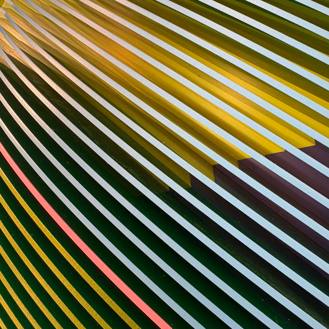 vertical stripes in green and blue with half split background in triangles on green and blue circular shape con-vexing sculptural out of center composition one pink line in middle