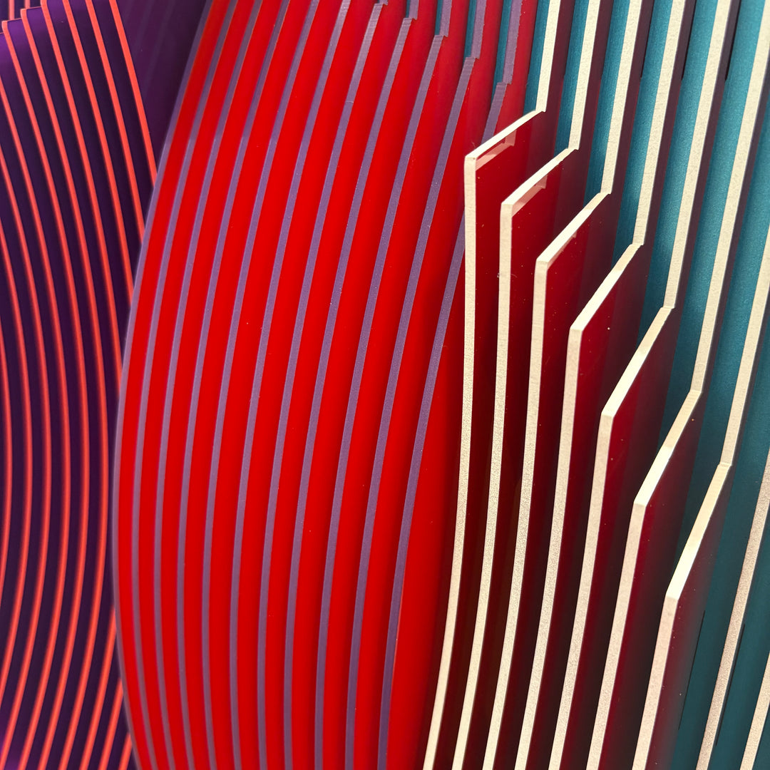 3 dimensional circular shape in center of vertical stripes square composition in red and blue white then when turned to side mostly red emerges optical illusion space color