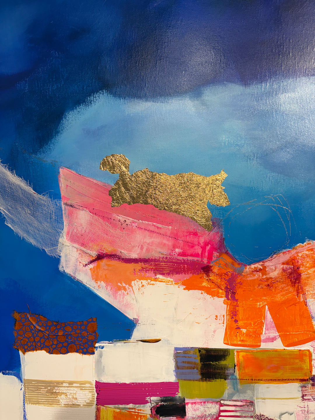 collage of paint fabric foil shapes built up in mountainous form in white pinks and orange on bright blue cloudy background abstract collage patterns 