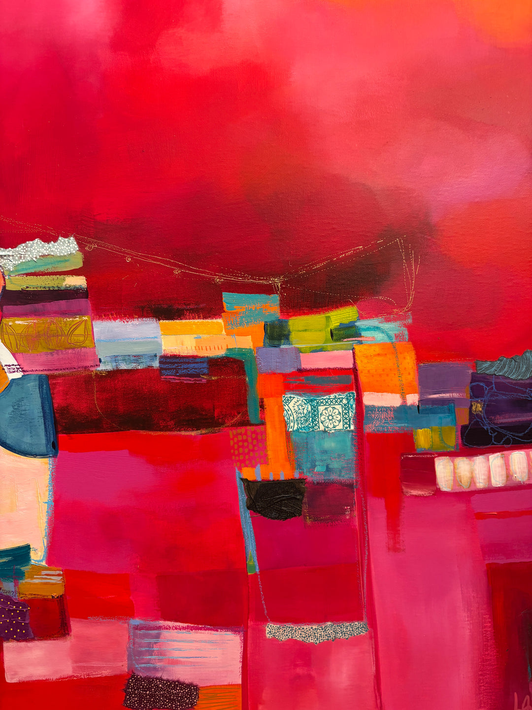 abstract collage of fabric french textile gold leaf acrylic paint shapes graphite in stacked form with blue green and orange shapes on a pink cloudy background