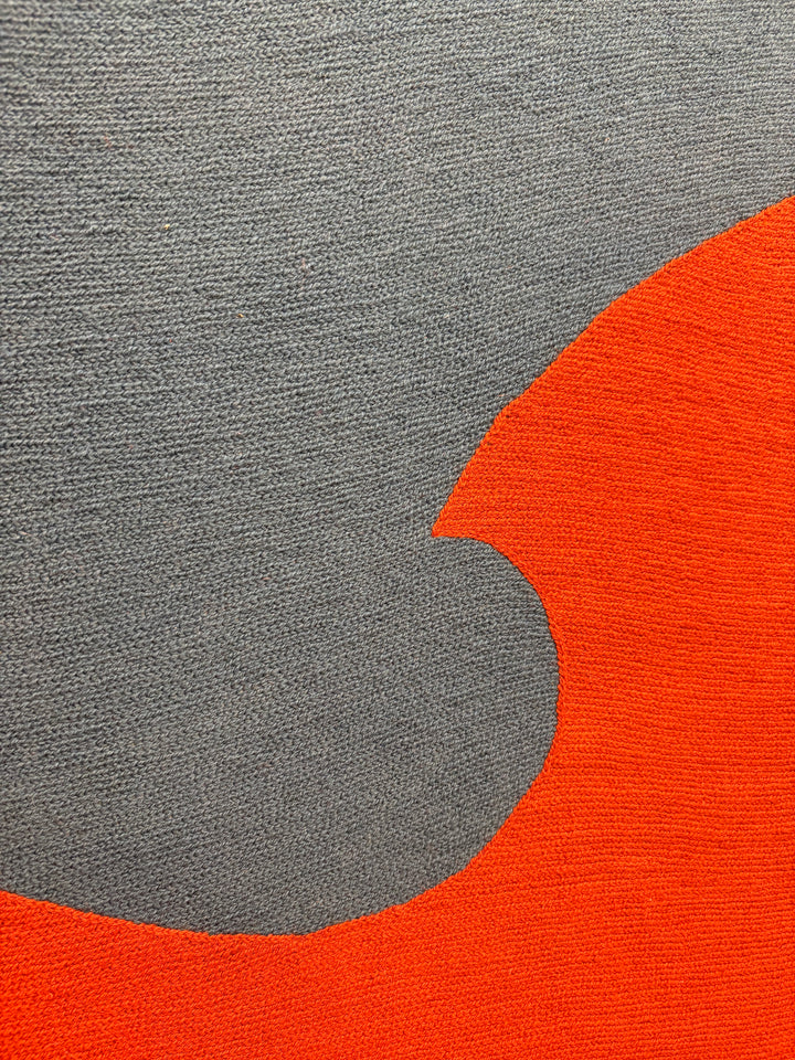 chain stitched embroidery textile fabric framed abstract geometric blue dot split composition negative space white and blue with orange wave in foreground