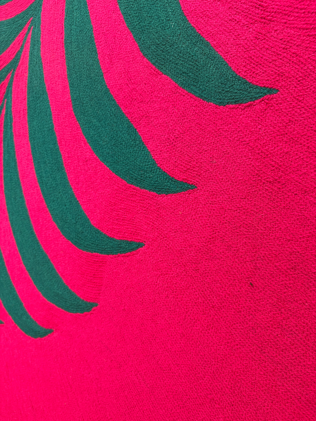 42.5"x42.5" chain-stitched textile with a tropical leaf over a bright pink background. 