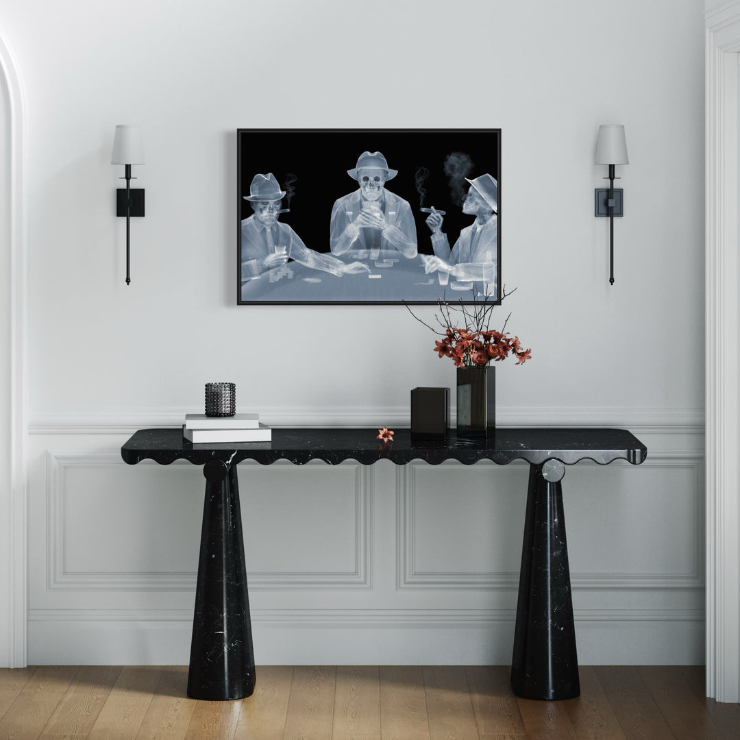 Framed Chromaluxe black and white x-ray photograph by Nick Veasey of three skeletal figures in fedoras and suits playing poker at a table and smoking cigars and holding drinks.