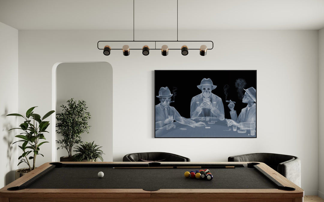 Framed Chromaluxe black and white x-ray photograph by Nick Veasey of three skeletal figures in fedoras and suits playing poker at a table and smoking cigars and holding drinks.
