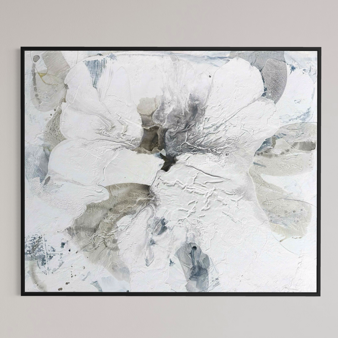 Liz Barber, Poppy 6, acrylic paint, ink, and watercolor on canvas, 72 x 60 inches. Large abstract white flower form with textured layered petals in white, pale gray, and taupe around a dark charcoal center, with gray-blue accents, shown in a black frame on a light gray wall.