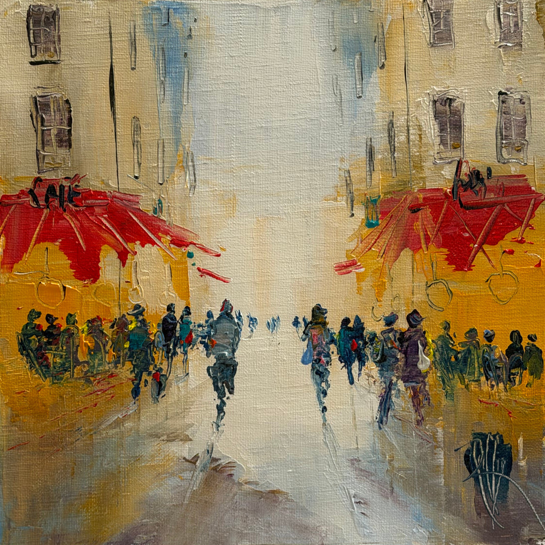 Christian Raffin, Sous Le Soleil, oil on canvas, 10 x 10 inches. A crowd of small figures beneath red café umbrellas along a street with pale buildings, the figures reflected on light, wet-looking pavement.