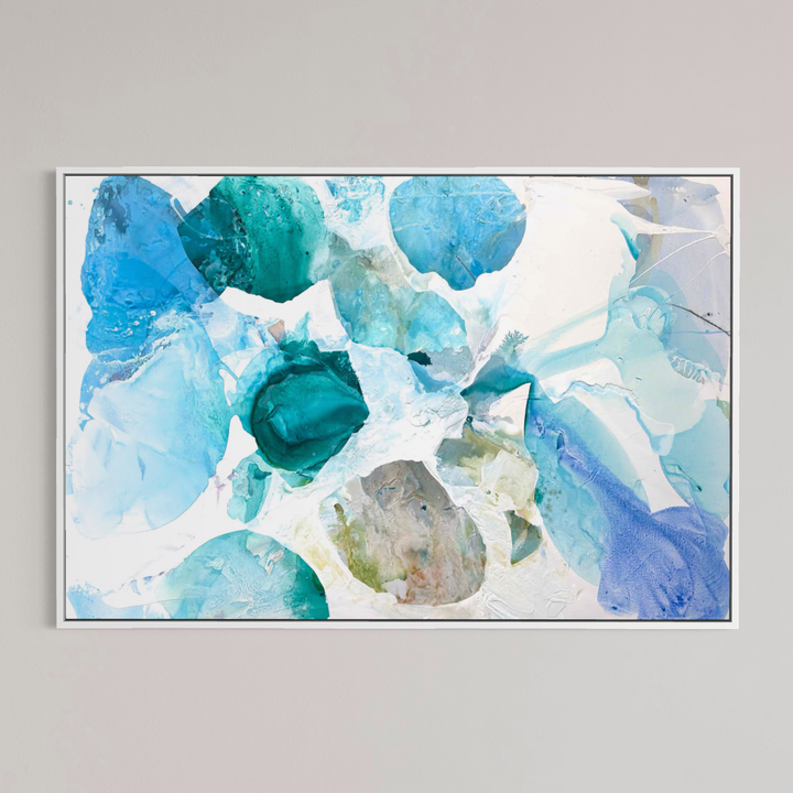Liz Barber, Summer Garden 10, acrylic paint, ink, watercolor, and graphite on canvas, 72 x 48 inches. Horizontal abstract composition of overlapping translucent shapes in turquoise, teal, sky blue, and periwinkle with a sage and beige shape near the center, on a white background, shown in a thin white frame on a light gray wall.