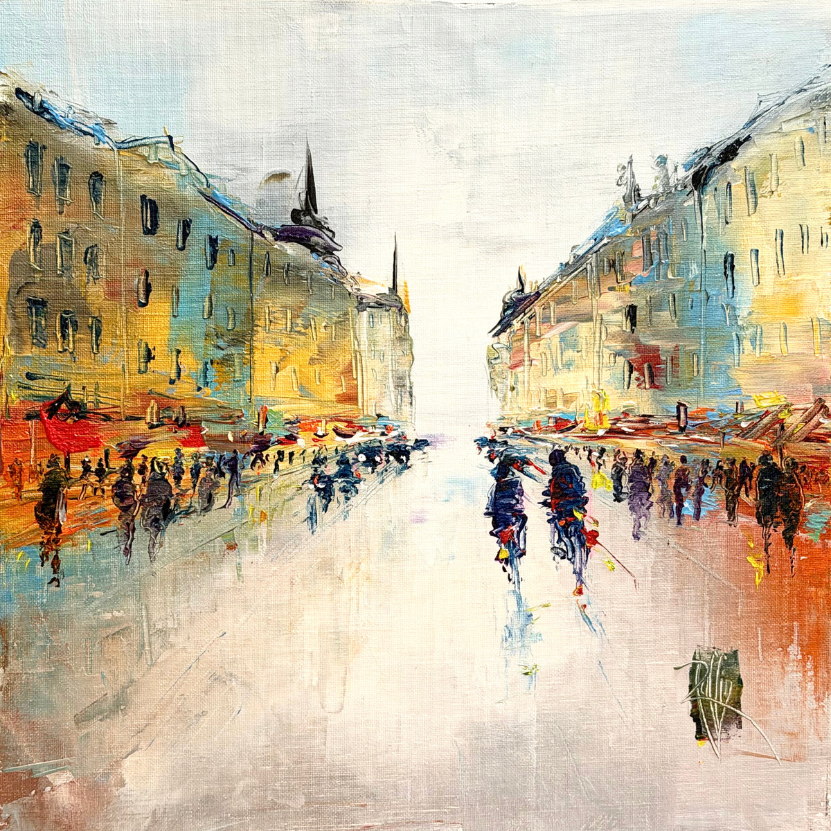 Christian Raffin, Vers 17h, oil on canvas, 14 x 14 inches. A street with yellow and cream buildings, a church spire on the left, red awnings, and two cyclists in blue riding down the center of a pale road among small figures.