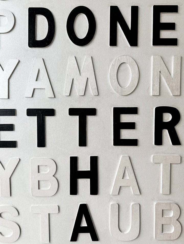 Contemporary 3D text artwork by Chicago artist Steffanie Gerkin titled Well Done 3D, featuring raised black and white wood letters arranged in a structured alphabet grid on a white canvas. The monochrome typographic composition spells the phrase “Well Done Is Better Than Well Said,” creating a bold conceptual wall art piece with graphic text-based design, pop art influence, and contemporary mixed-media style.