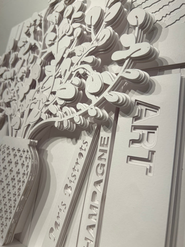 14"x14" layered white paper forming a vase with a fern over a wall.  