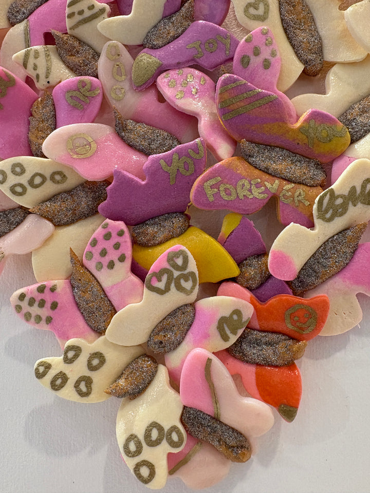 3 dimensional textured artwork of butterflies with text and floral collage on white background with pink and beige clay model paste acrylic in heart shape
