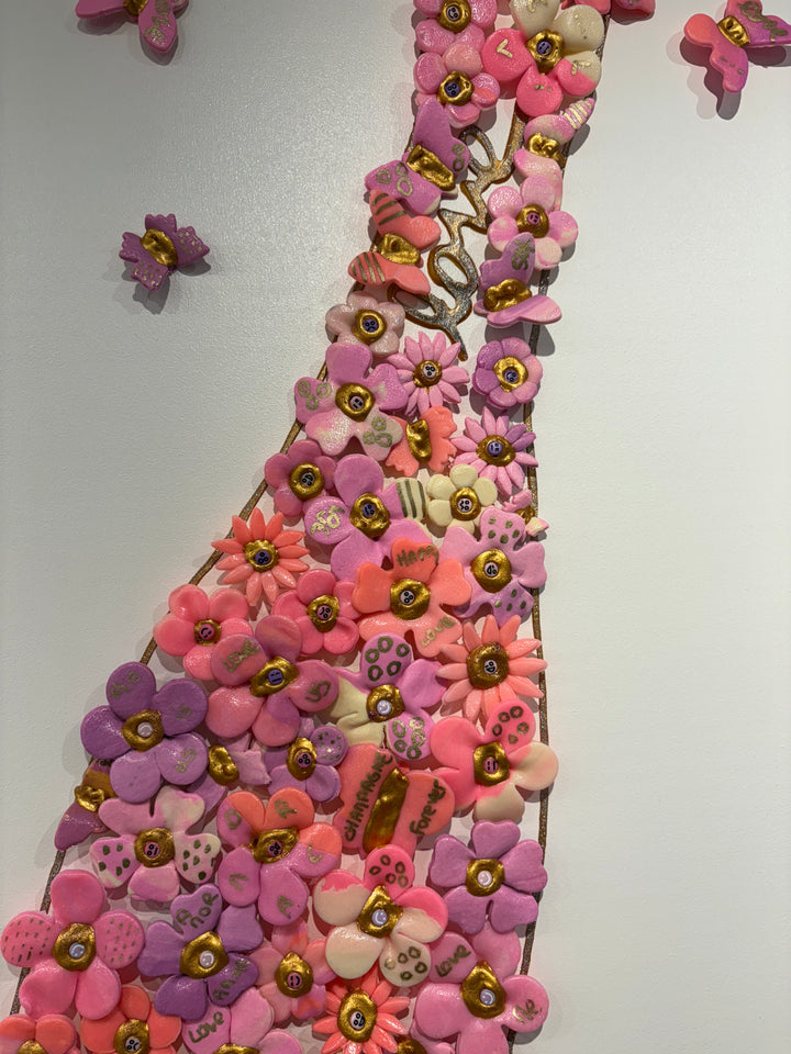 Acrylic clay and modeling paste painting of bottle champagne of pink 3 dimensional flowers coming out of bottle to butterflies on white canvas